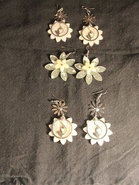 Earrings three for one price. Plastic flowers & cats. Good.